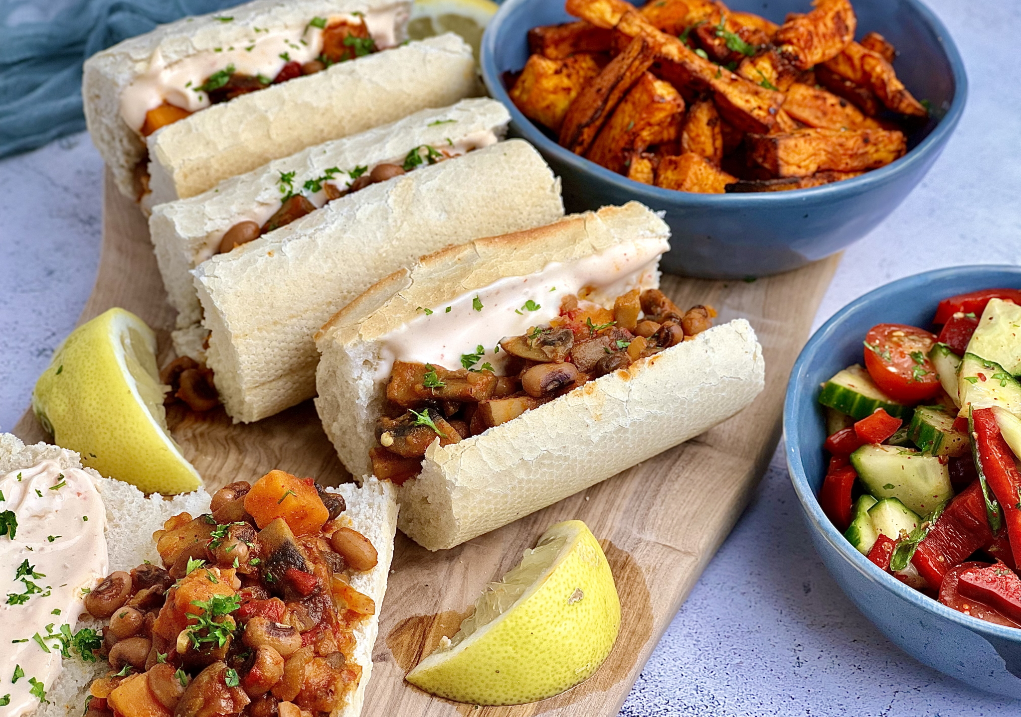 Vegan Ndambé Sandwich, a vegan take on a Senegalese street food sandwich. Crusty baguette and a spicy filling made with mushrooms, black eyed beans and sweet potato.