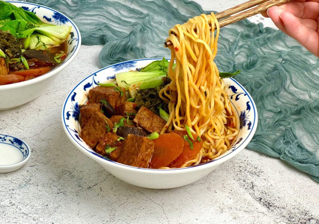 Spiced broth with noodles and tempeh.