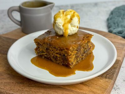 vegan sticky toffee pudding served with ice cream and caramel sauce